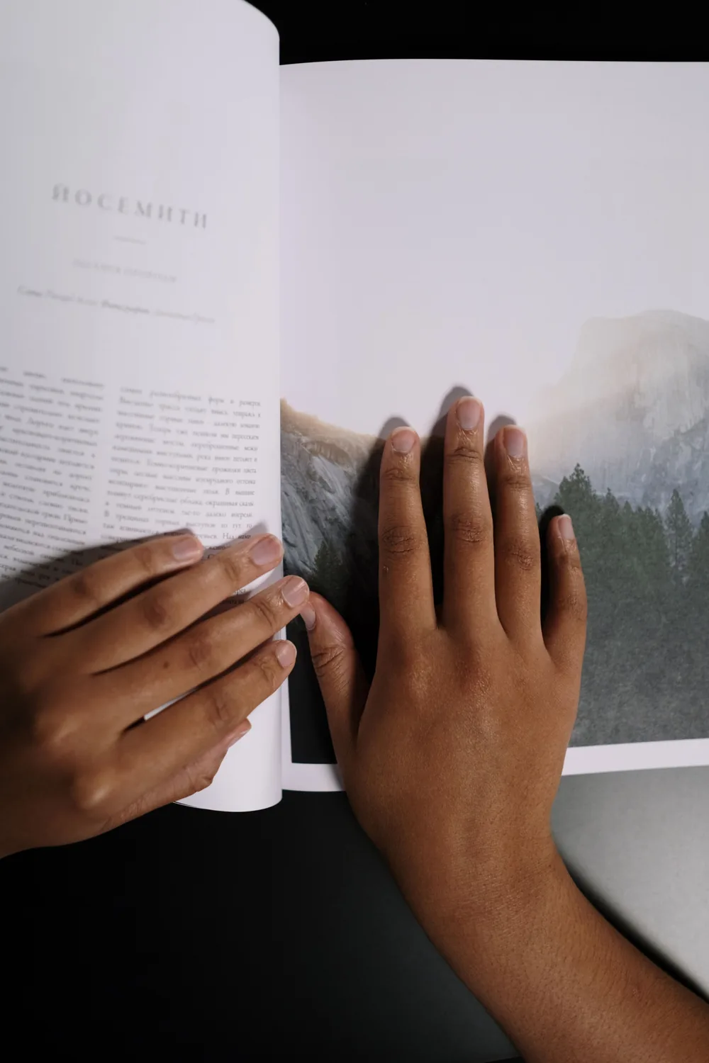 Hands resting on the pages of an open book