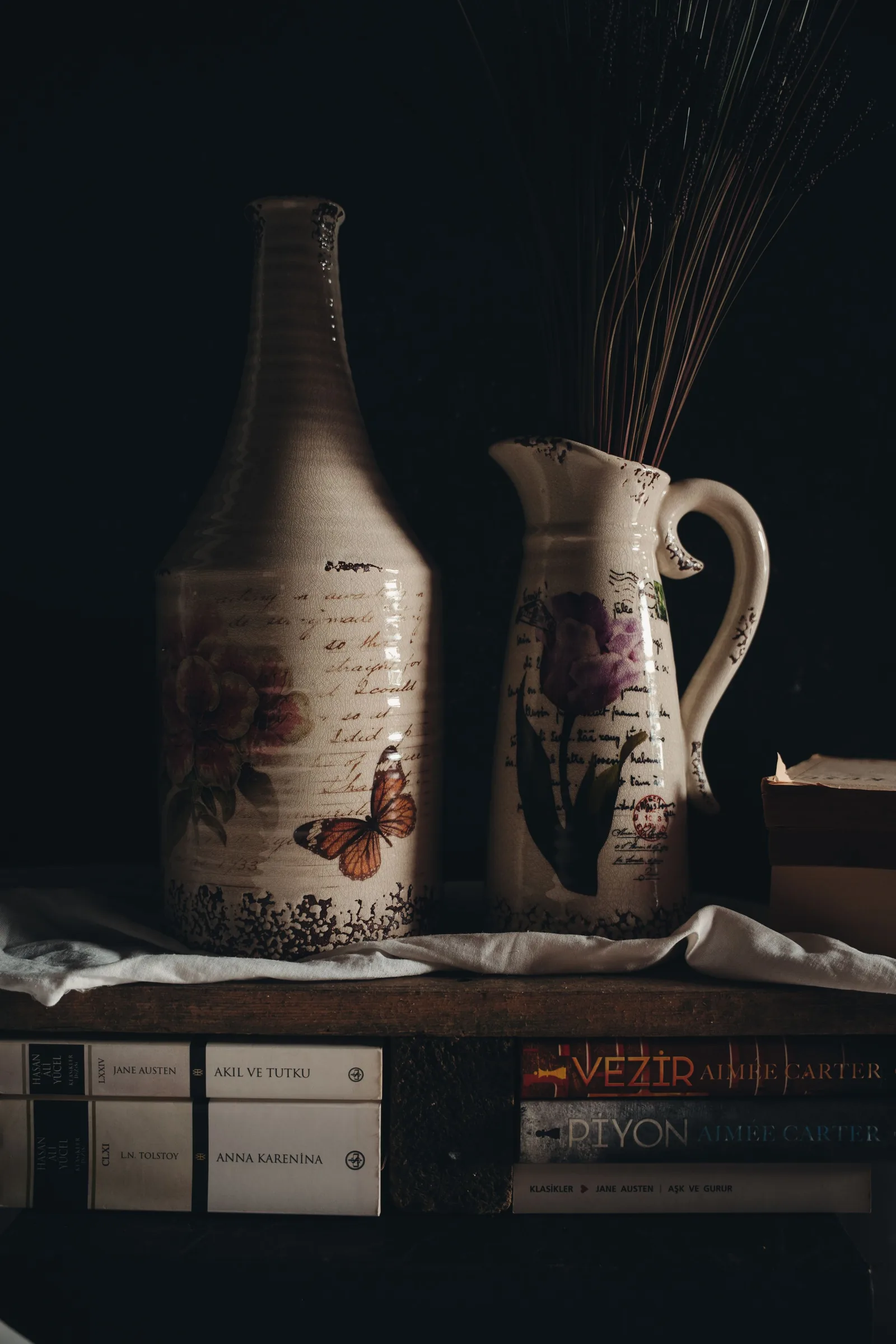 Vintage ceramic vases next to old books