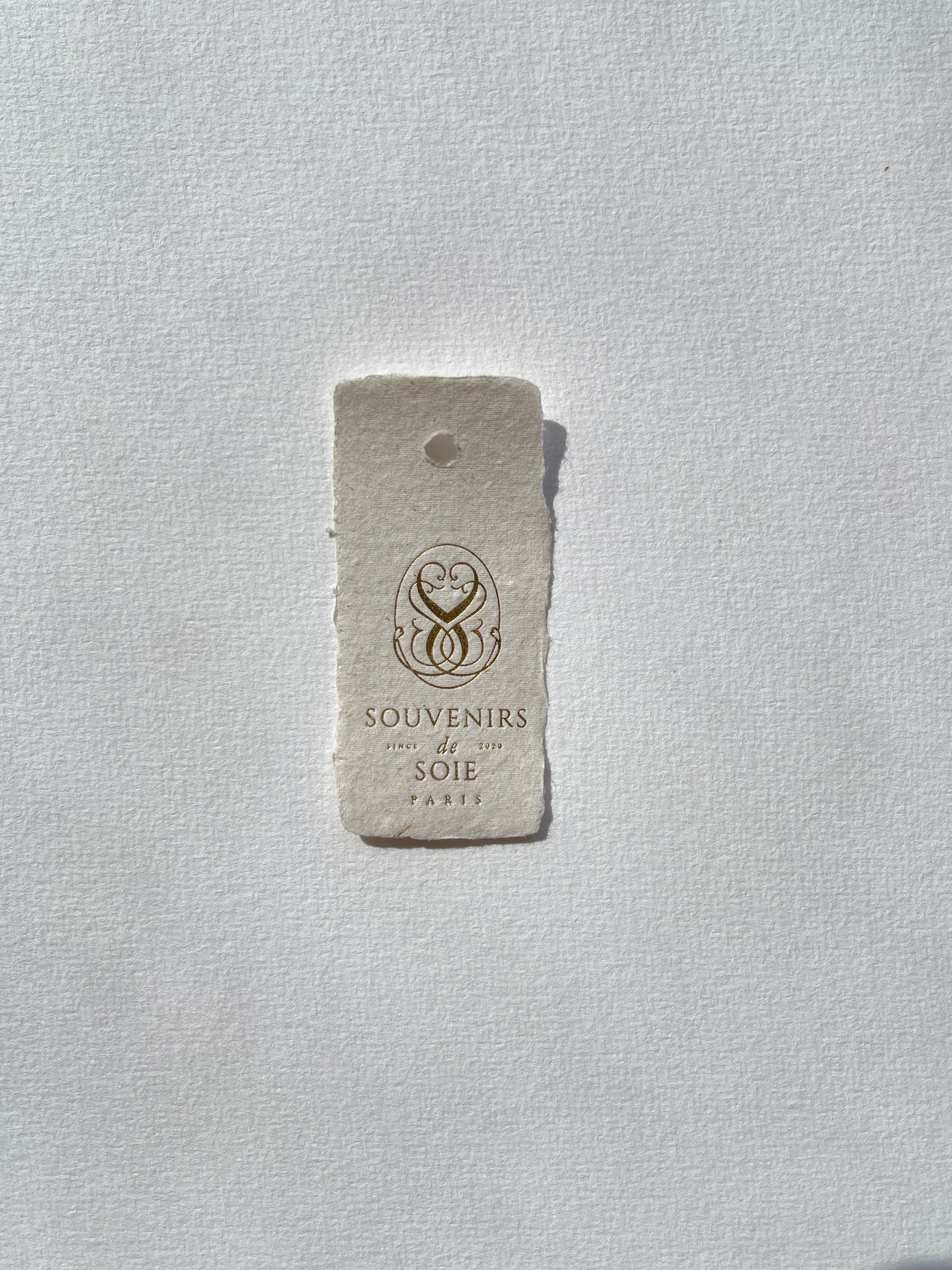 Sunlight falling on a small sticker on a white wall