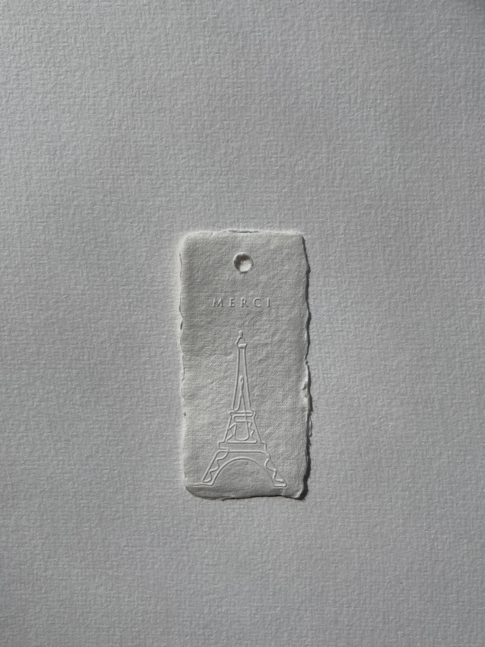 An embossed card on white paper