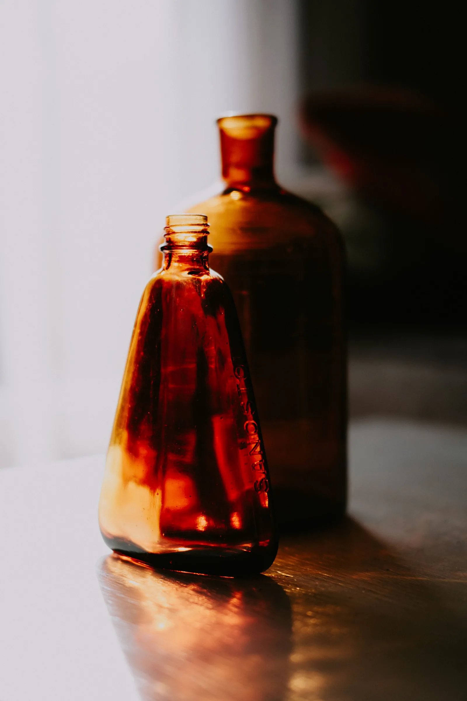 A glass flask and bottle with liquid