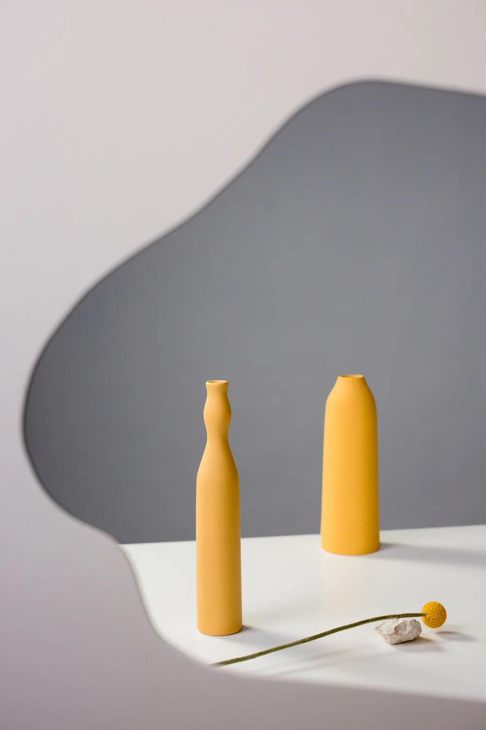 Yellow ceramic vases on a white table for Ember Ceramics