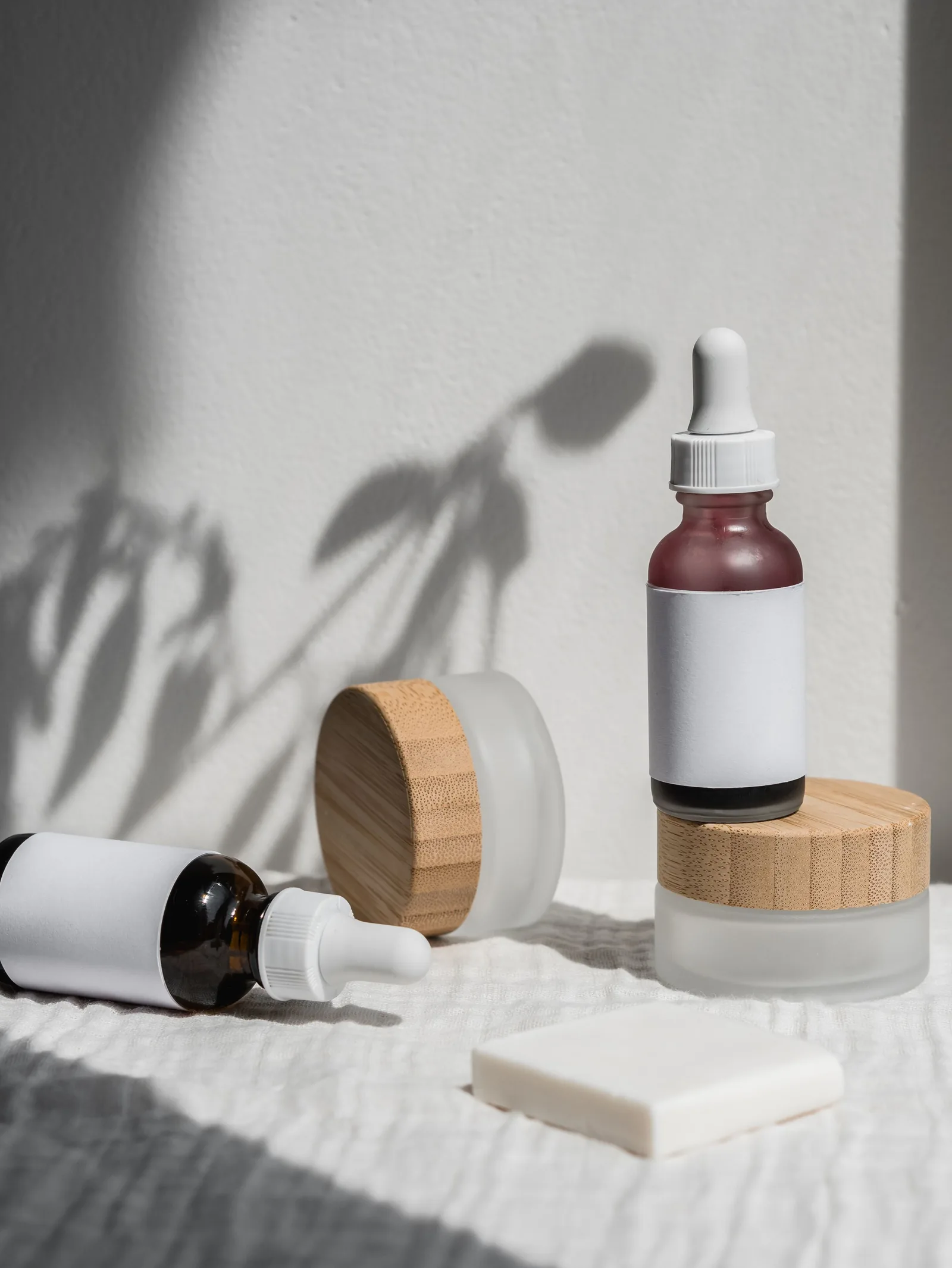 Amber skincare containers in soft shadow